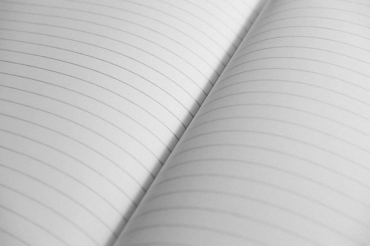 services-01 High-resolution close-up of an open notebook with lined pages, perfect for stationery concepts.